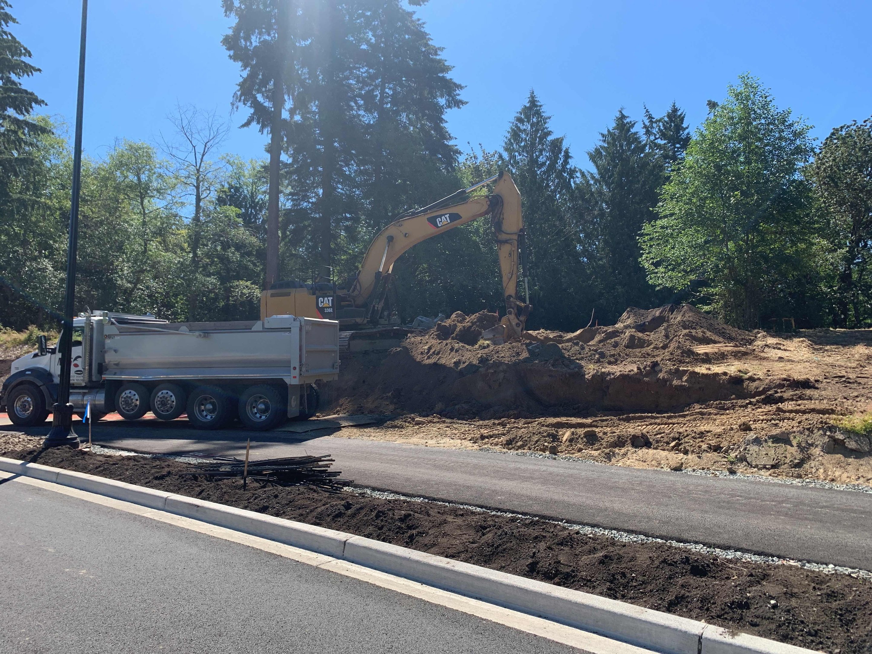 Dump truck and excavator moving earth on a Washington construction site